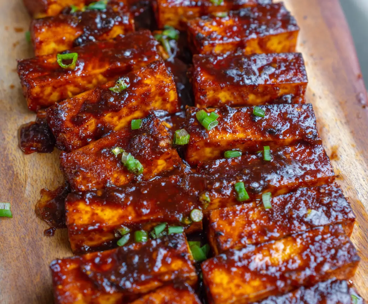 Delicious BBQ tofu slabs grilled to perfection with smoky barbecue sauce and appealing grill marks.