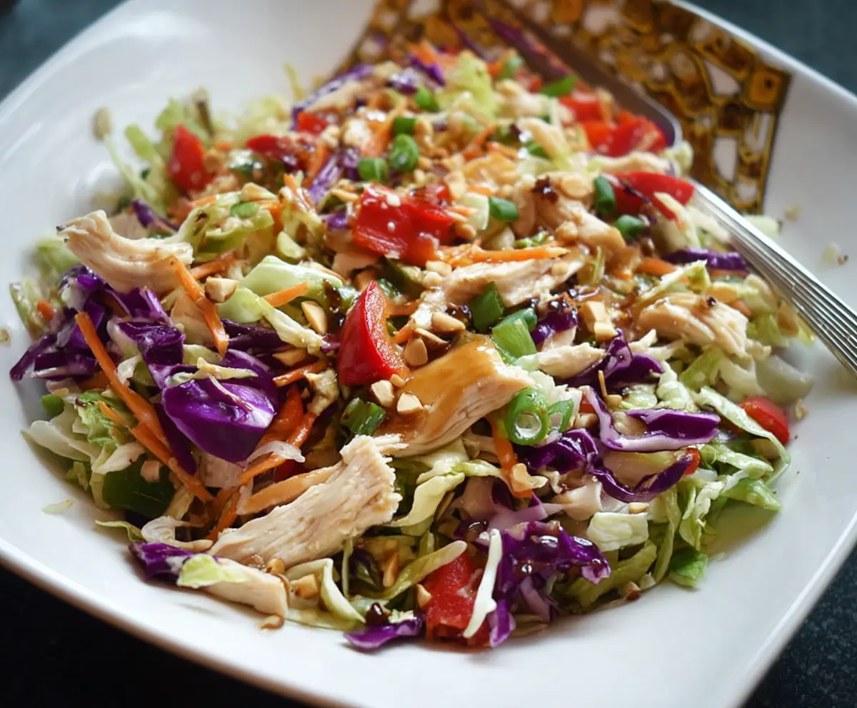 Colorful Chinese Chicken Chopped Salad with fresh vegetables and shredded chicken in a bowl.