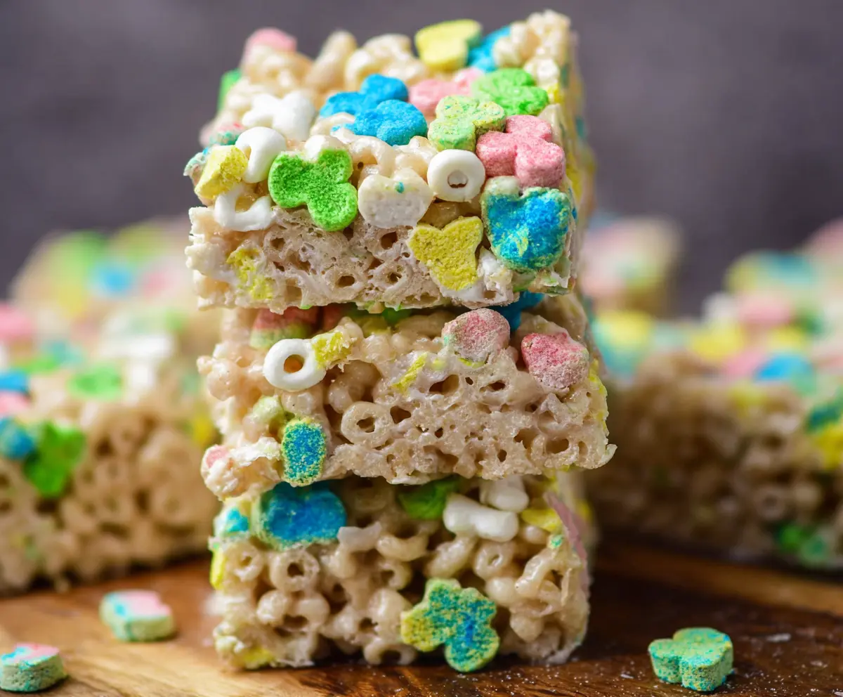 Colorful Lucky Charms Rice Krispie Treats featuring marshmallow cereal bars on a white platter