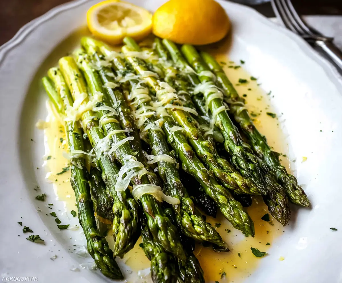 Fresh lemon butter asparagus dish featuring tender asparagus spears drizzled with zesty lemon butter sauce.